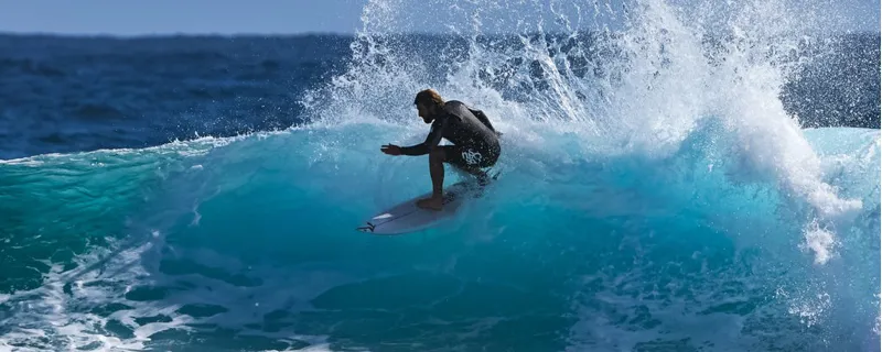 surfer wearing c skins wetsuit in a barrel wave